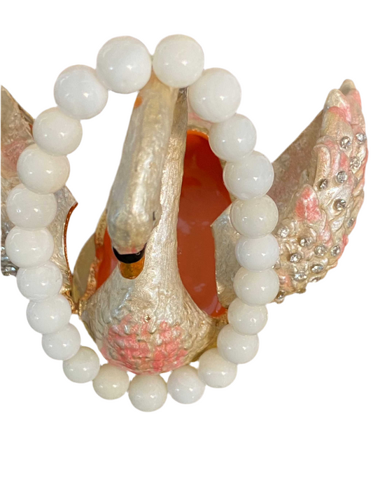 White Jade Beaded Sting Bracelet 7mm displayed with a decorative swan.