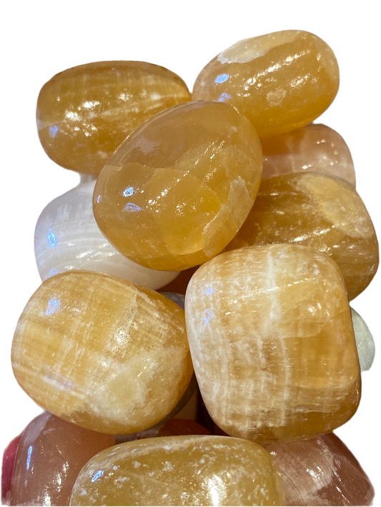 Polished Honey Calcite tumbled stones, highlighting quality and golden hues.