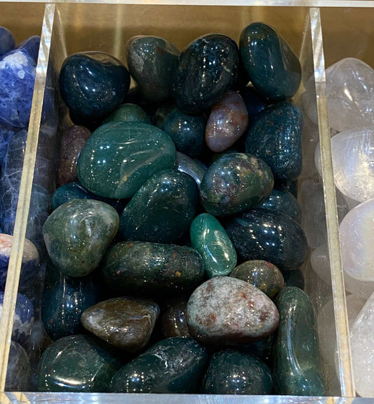 Bloodstone tumbled stones in various shapes and sizes displayed in a box.