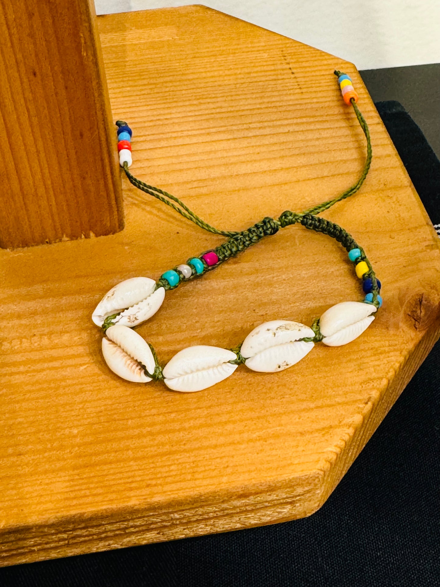 Handmade Army Green String Bracelet With Cowrie Shells and Colorful Beads “Boho charm meets ocean energy — wear abundance on your wrist.”