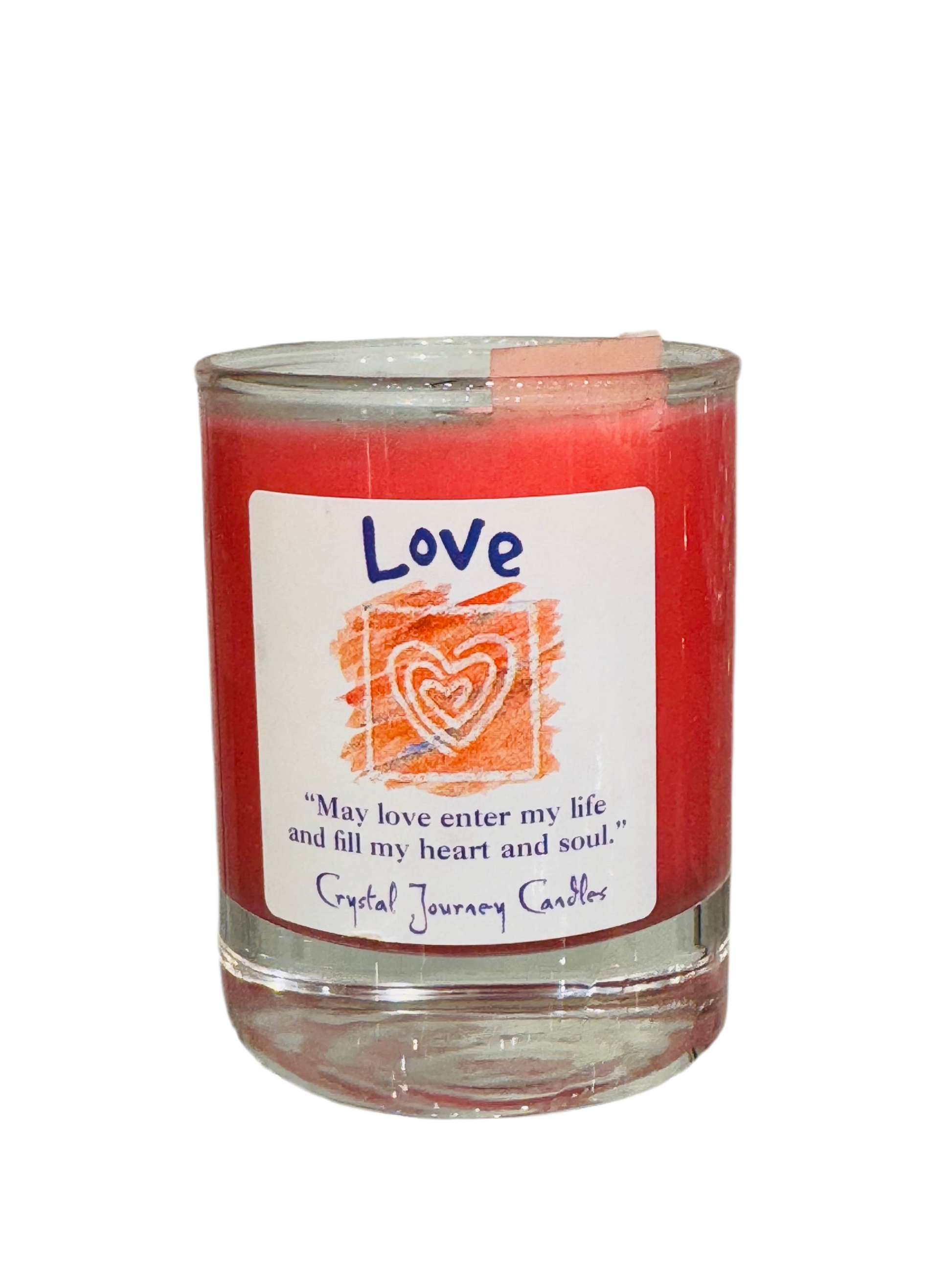 Love Crystal Journey Filled Glass Votive with pink hue and aromatic blend.
