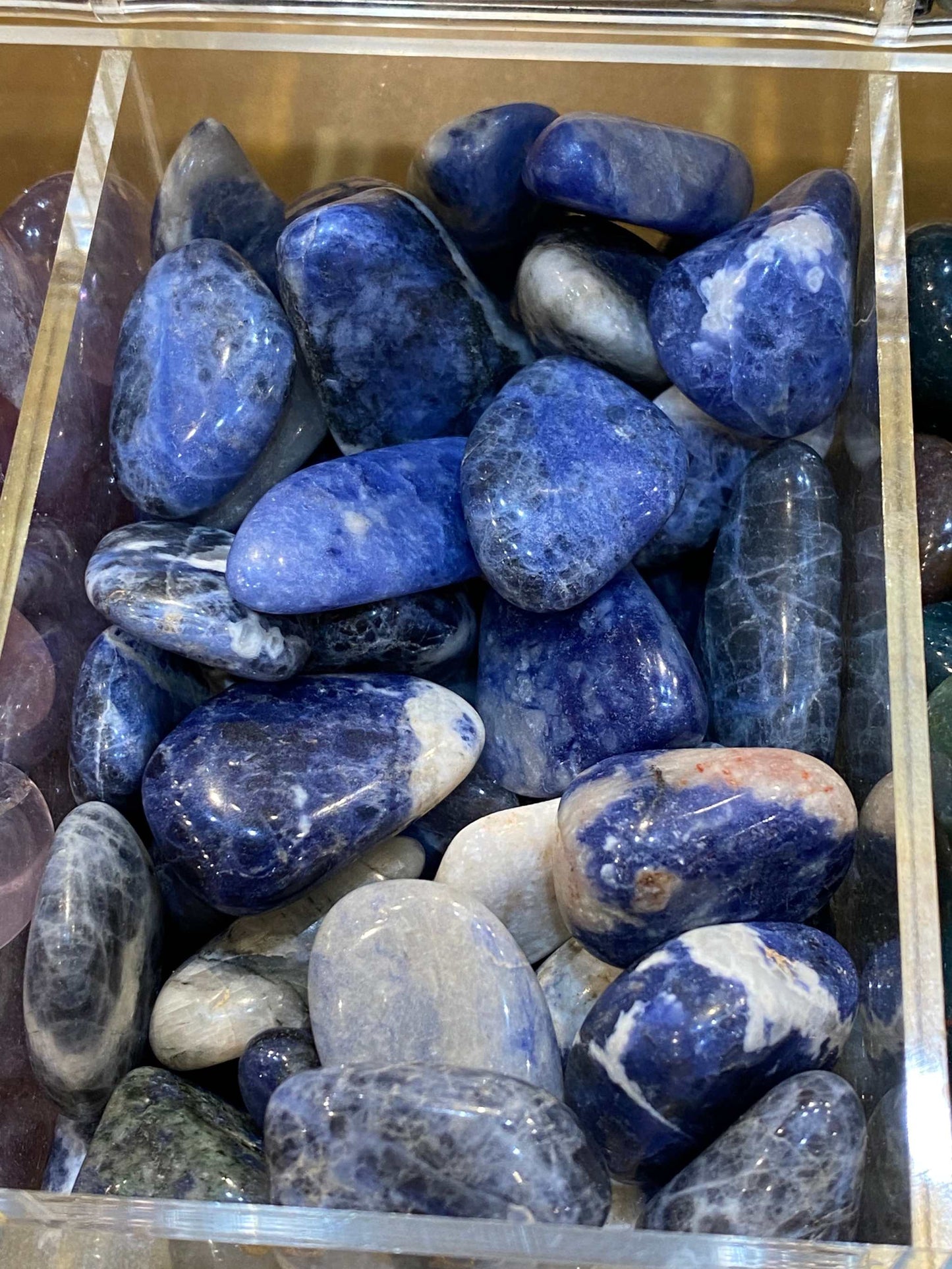 Sodalite Tumbled Stones in varying colors and sizes for communication and self-expression.