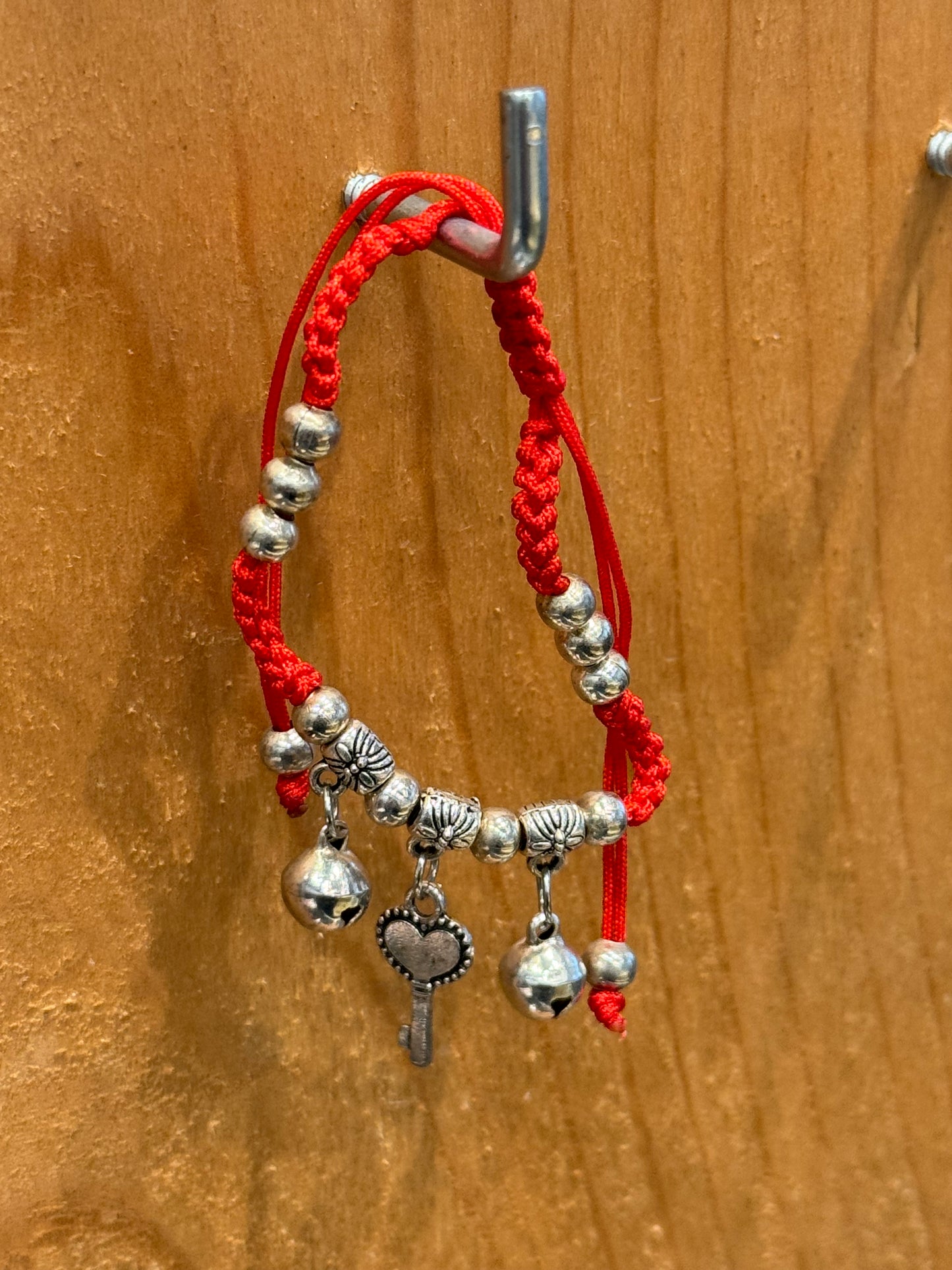 Red String Braided Pull Tie Bracelet with Silver Beads, Bells and Key Charm