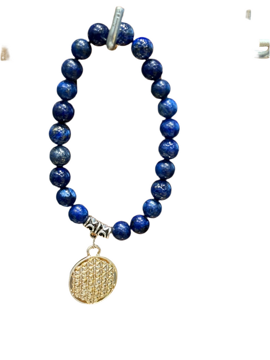 Lapis Lazuli Gemstone Bracelet with Flower of Life charm, deep blue with golden flecks, enhancing wisdom and spiritual connection.