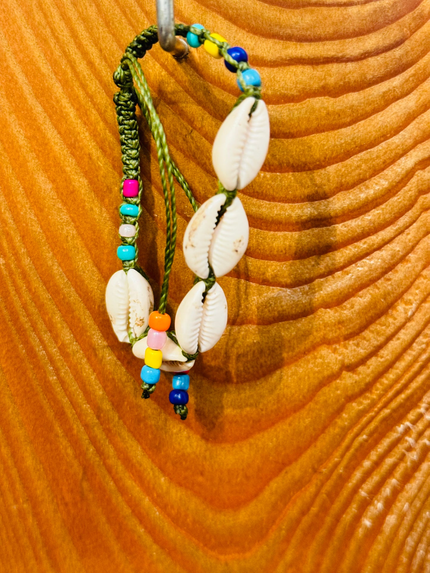 Handmade Army Green String Bracelet With Cowrie Shells and Colorful Beads “Boho charm meets ocean energy — wear abundance on your wrist.”