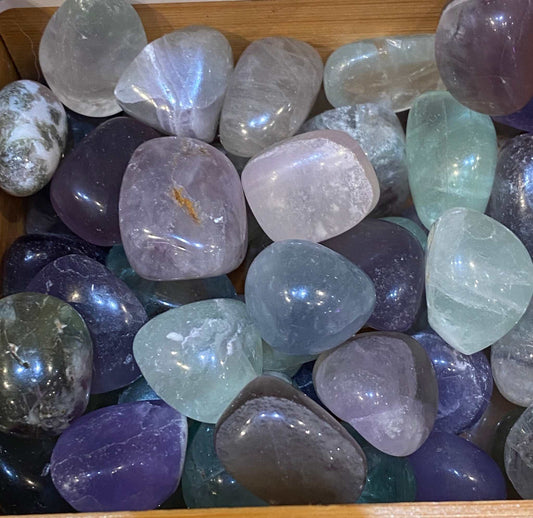 Rainbow Fluorite Crystal Polished Tumbled Stones in various colors in a wooden box.