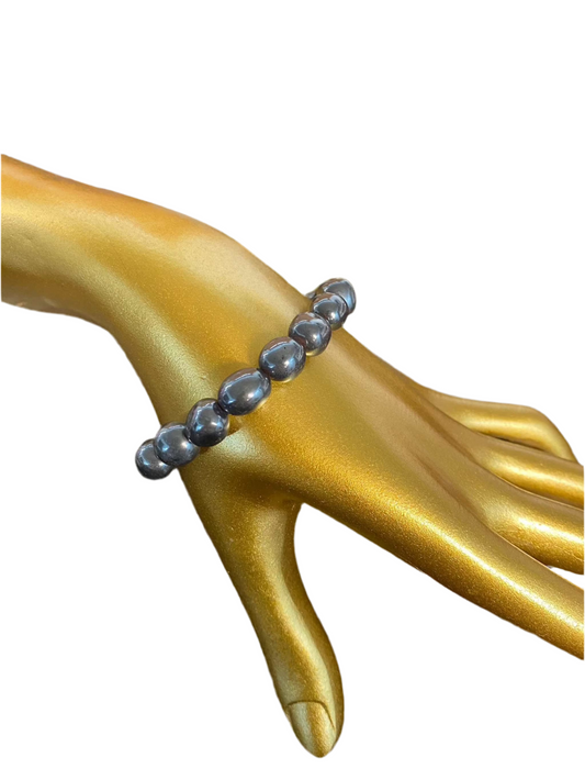 Hematite Nugget String Bracelet 8mm on gold mannequin hand.