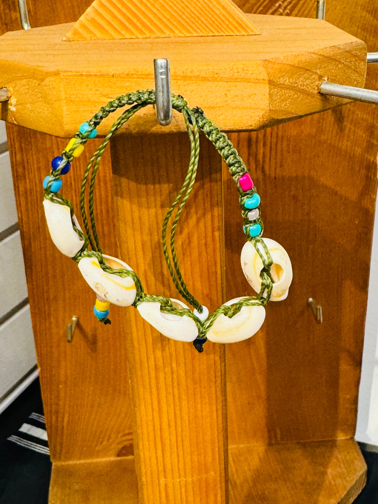 Handmade Army Green String Bracelet With Cowrie Shells and Colorful Beads “Boho charm meets ocean energy — wear abundance on your wrist.”