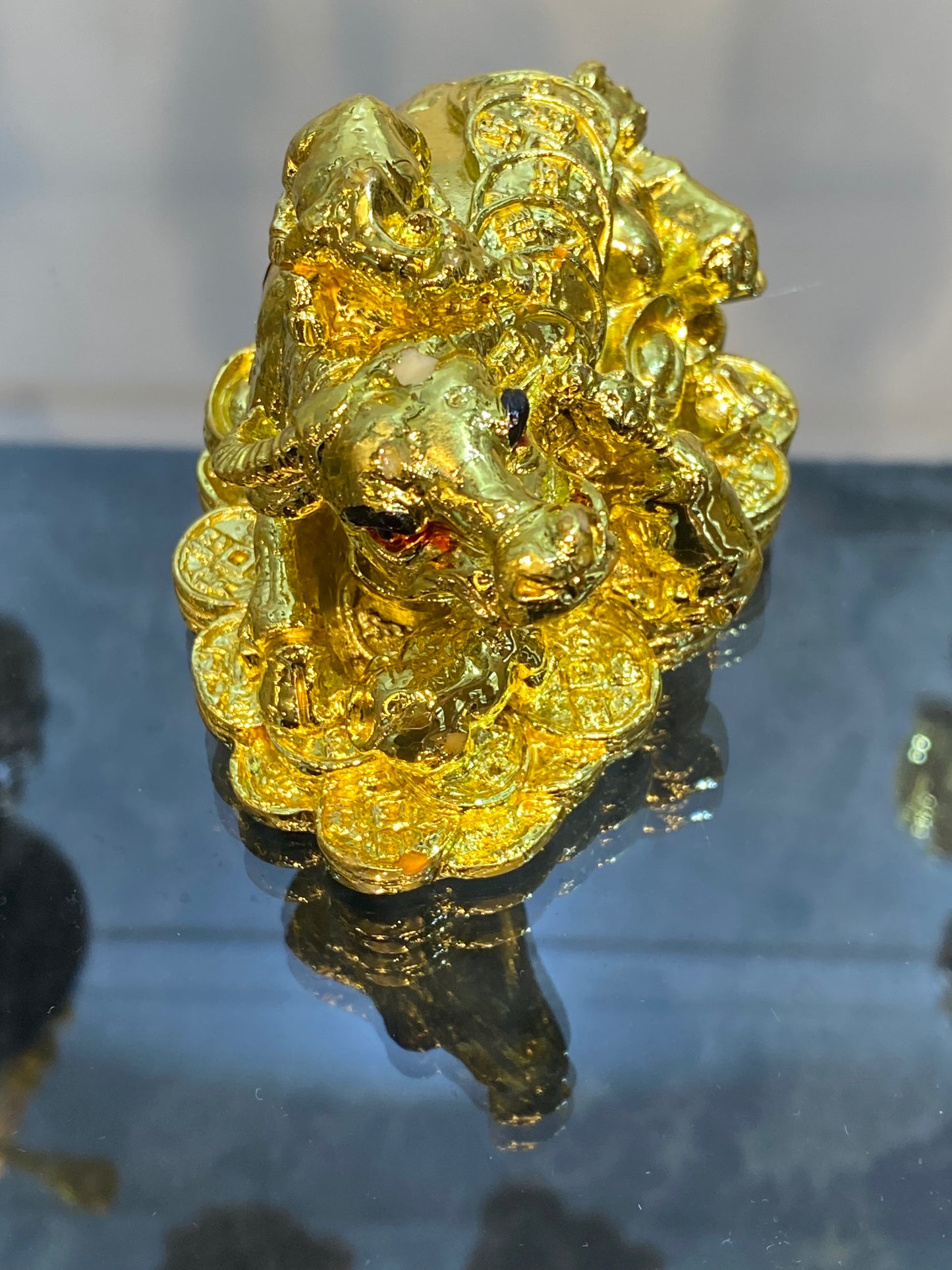 Feng Shui Shiny Gold Colored Money Ox With Baby Ox sitting on Coins