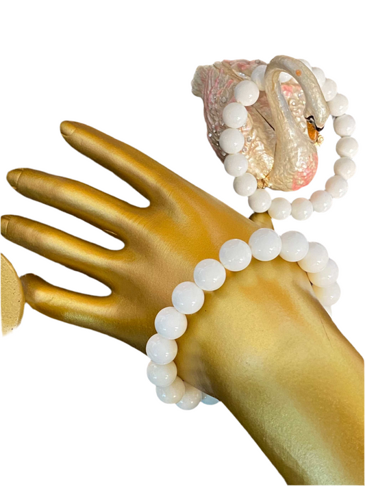 White Jade Beaded String Bracelet with 10mm stones on mannequin hand, symbolizing purity and protection.