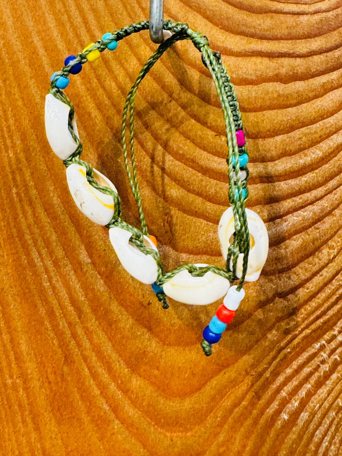 Handmade Army Green String Bracelet With Cowrie Shells and Colorful Beads “Boho charm meets ocean energy — wear abundance on your wrist.”