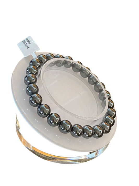 Hematite Round Beaded String Bracelet 8mm displayed on a stand.
