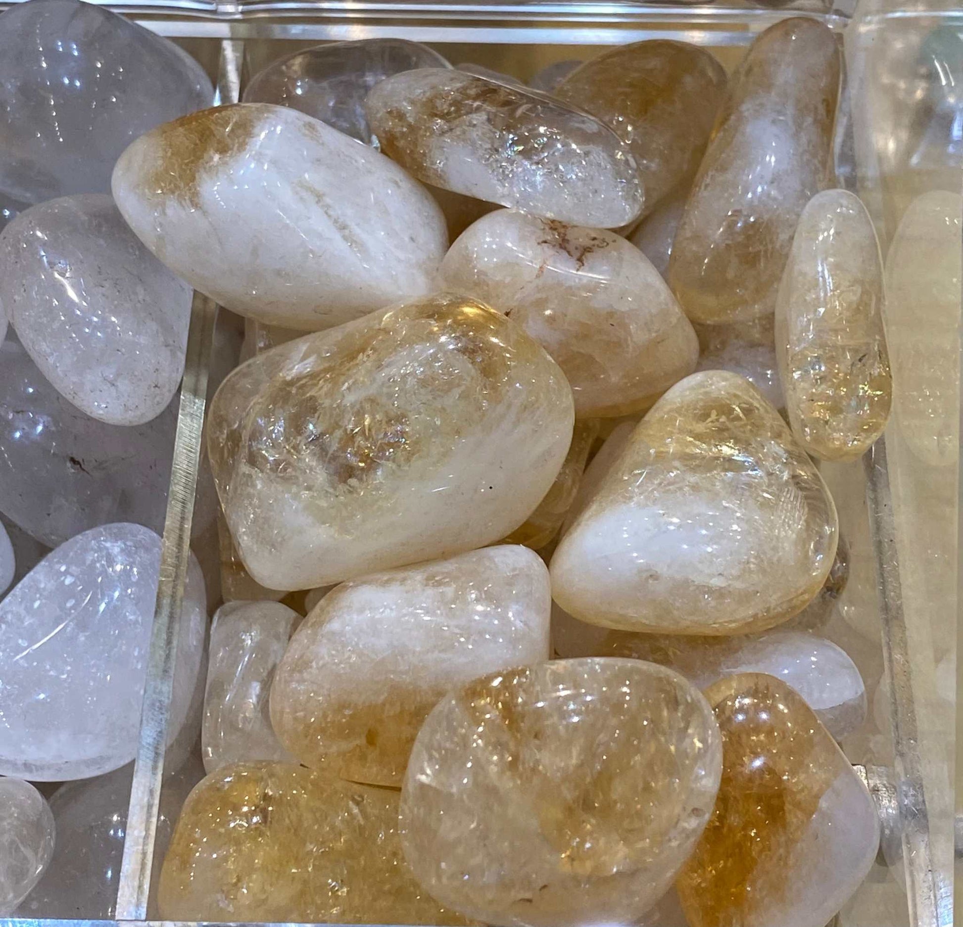Citrine Tumbled Stone for wealth and prosperity, quarter size, in a pile.