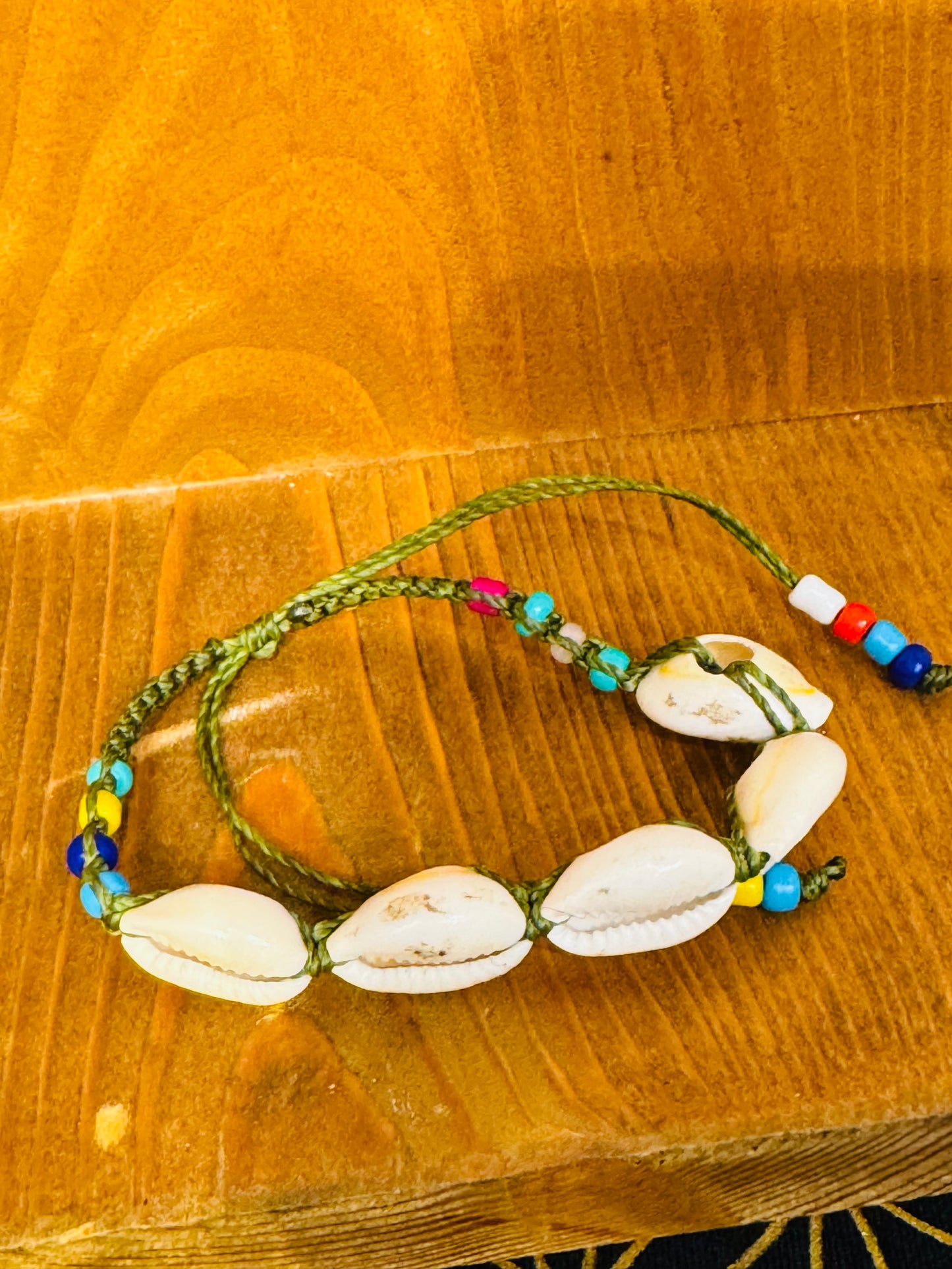Handmade Army Green String Bracelet With Cowrie Shells and Colorful Beads “Boho charm meets ocean energy — wear abundance on your wrist.”