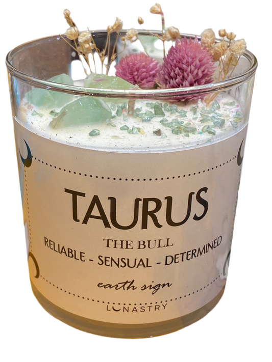 Taurus candle with flowers and crystals by Lunastry, highlighting reliability and sensuality for the zodiac earth sign.