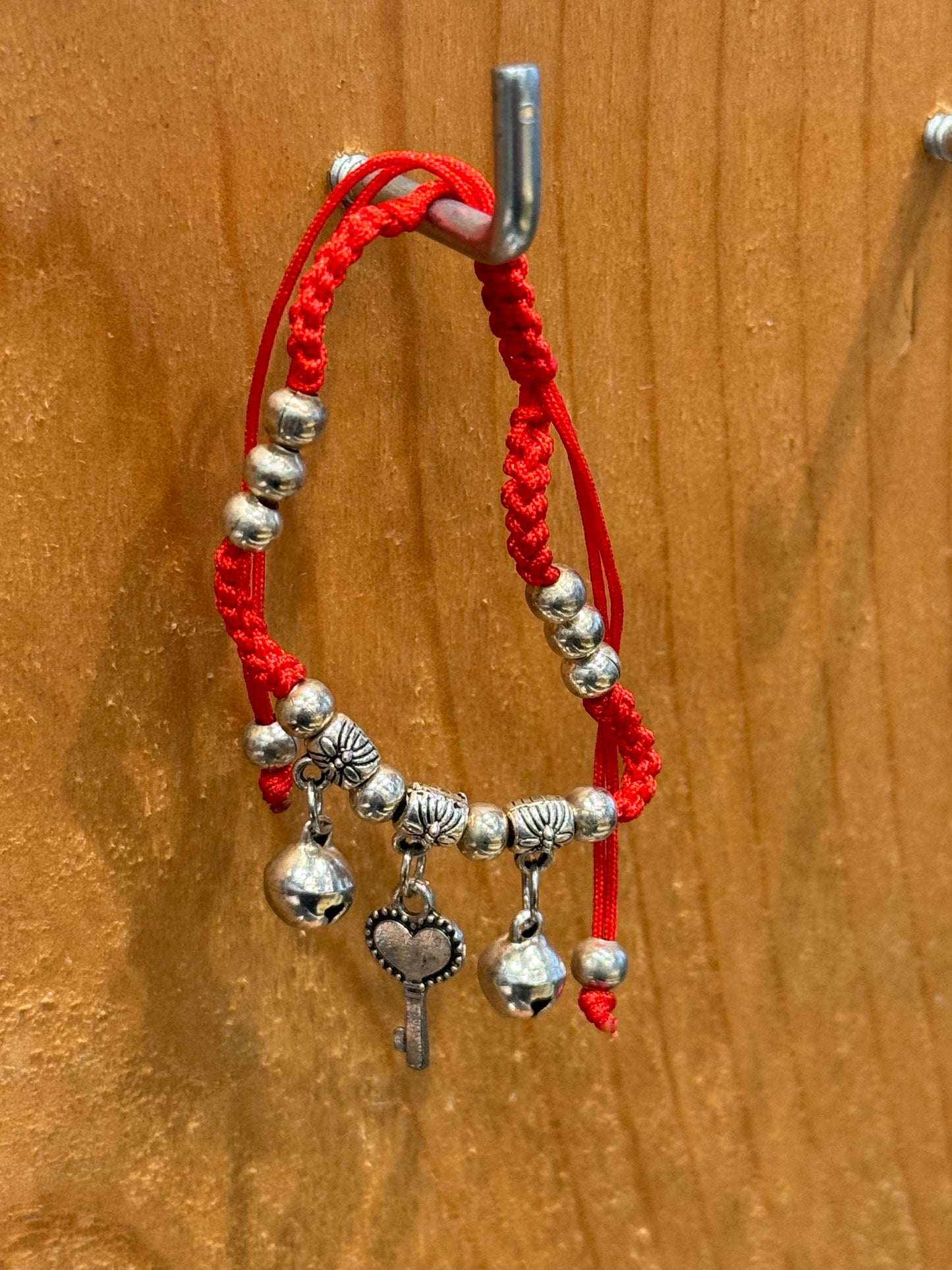 Red String Braided Pull Tie Bracelet with Silver Beads, Bells and Key Charm