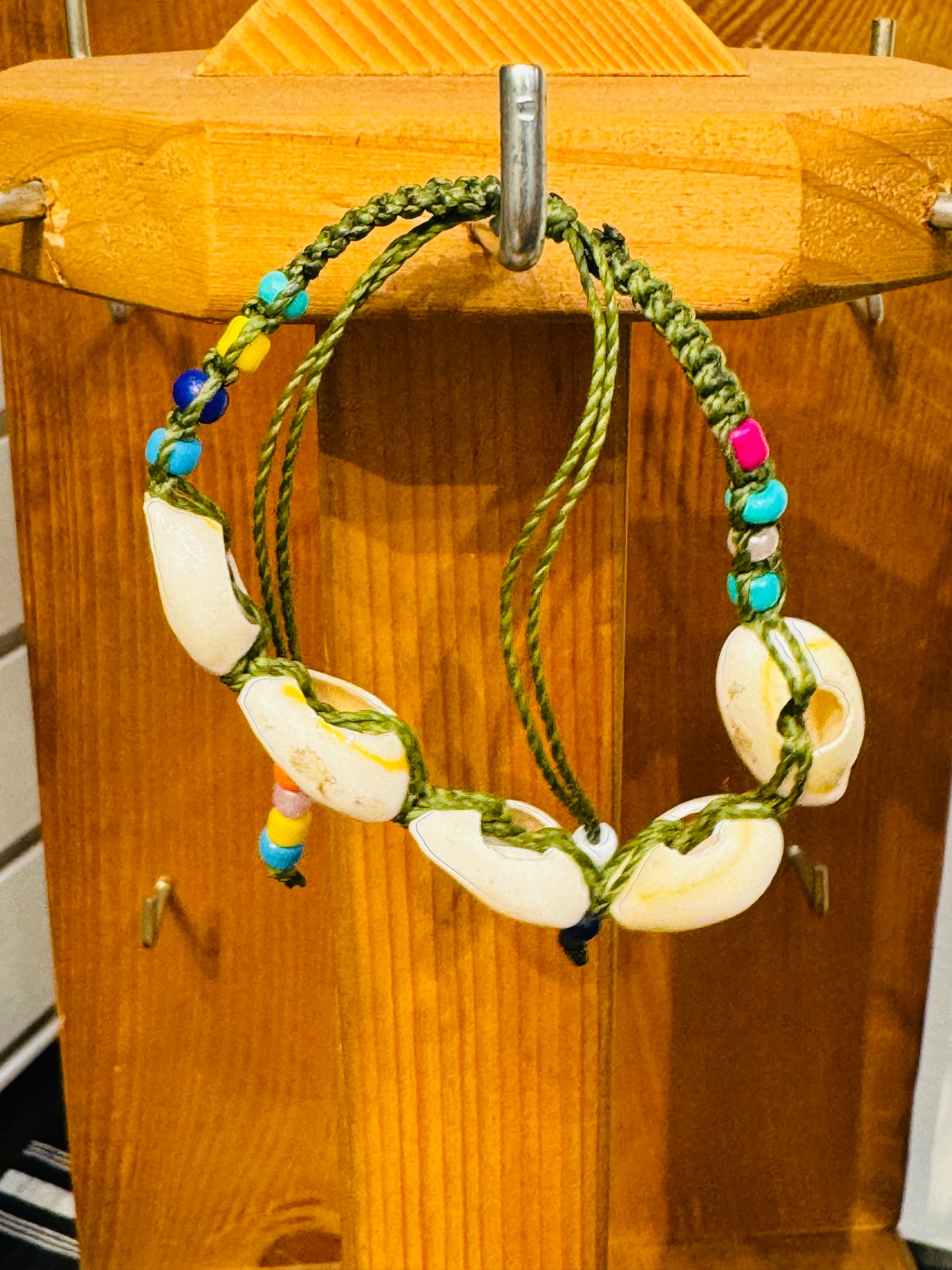 Handmade Army Green String Bracelet With Cowrie Shells and Colorful Beads “Boho charm meets ocean energy — wear abundance on your wrist.”