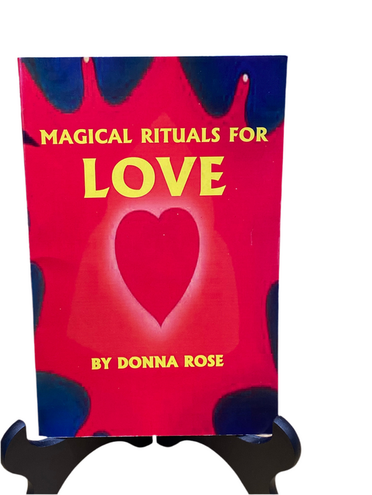 Magical Rituals For Love book by Donna Rose on a stand with heart design on cover.