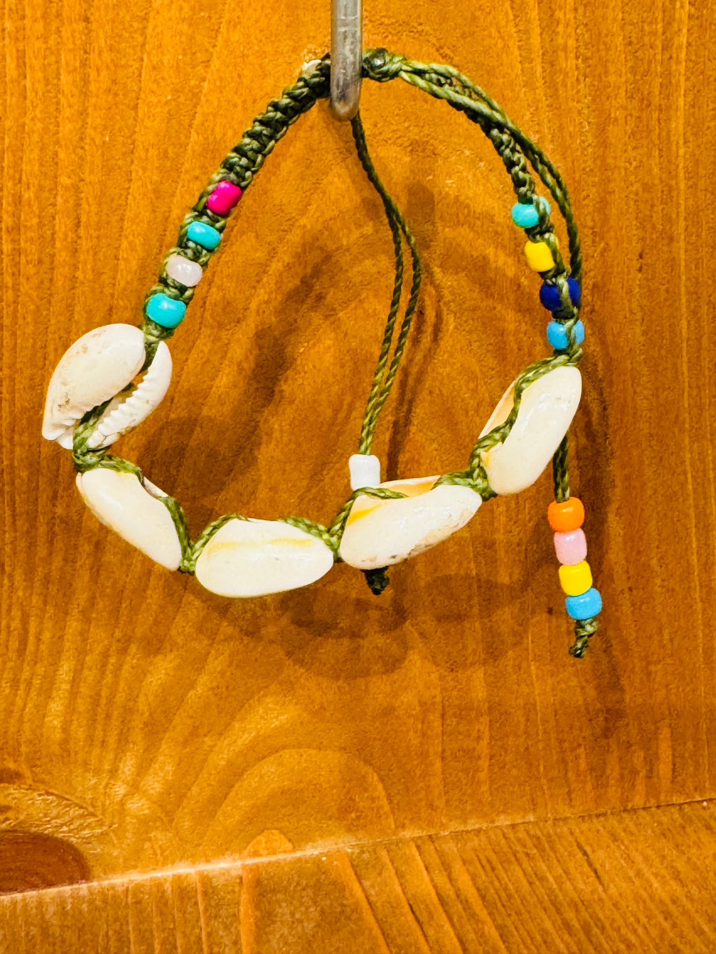 Handmade Army Green String Bracelet With Cowrie Shells and Colorful Beads “Boho charm meets ocean energy — wear abundance on your wrist.”