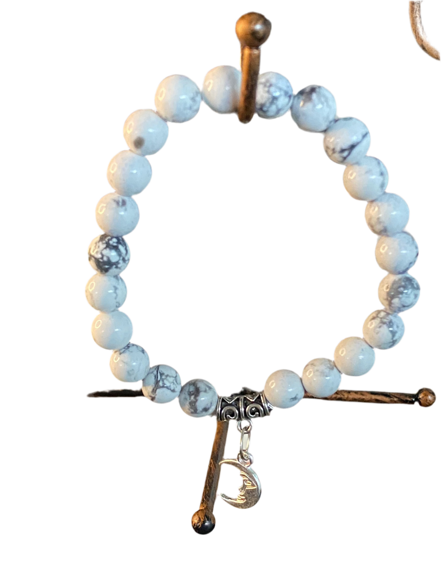 Howlite Gemstone Bracelet with Crescent Moon Charm, symbolizing peace and wisdom.