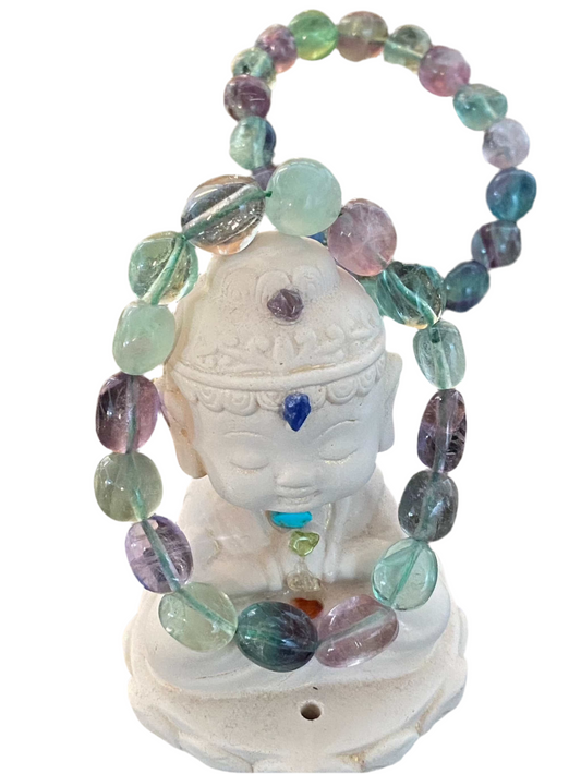 Rainbow Fluorite Round Tumbled Gemstone Bracelet with 8mm beads displayed on a decorative statue.