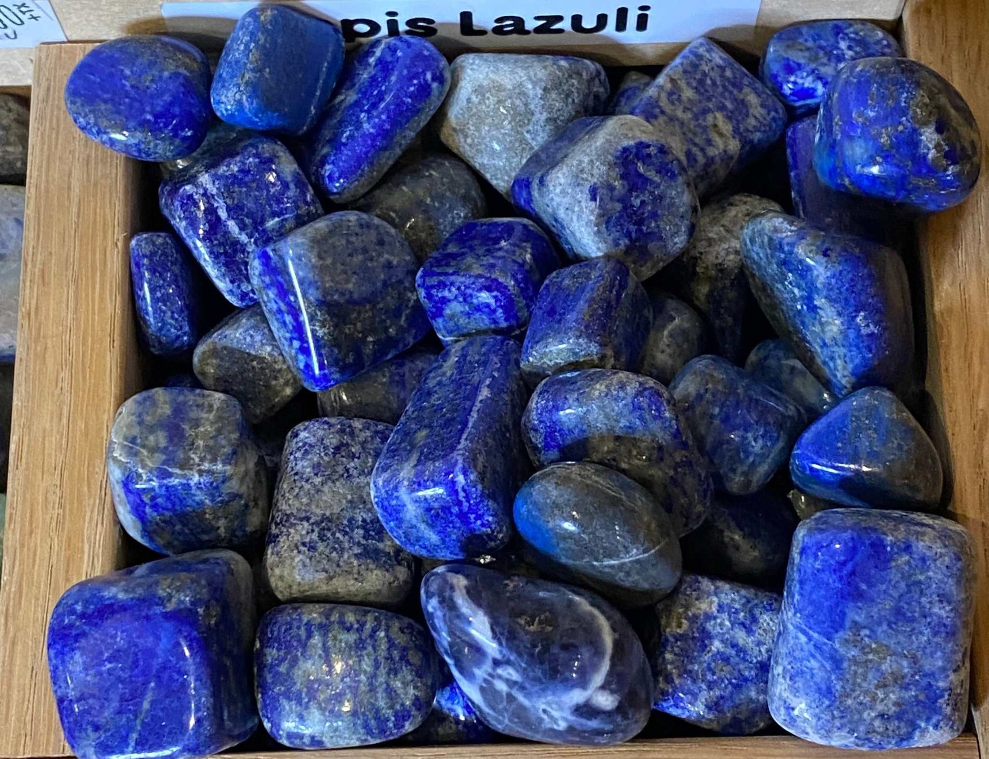Lapis Lazuli tumbled stones showcasing vivid blue hues and polished surfaces.