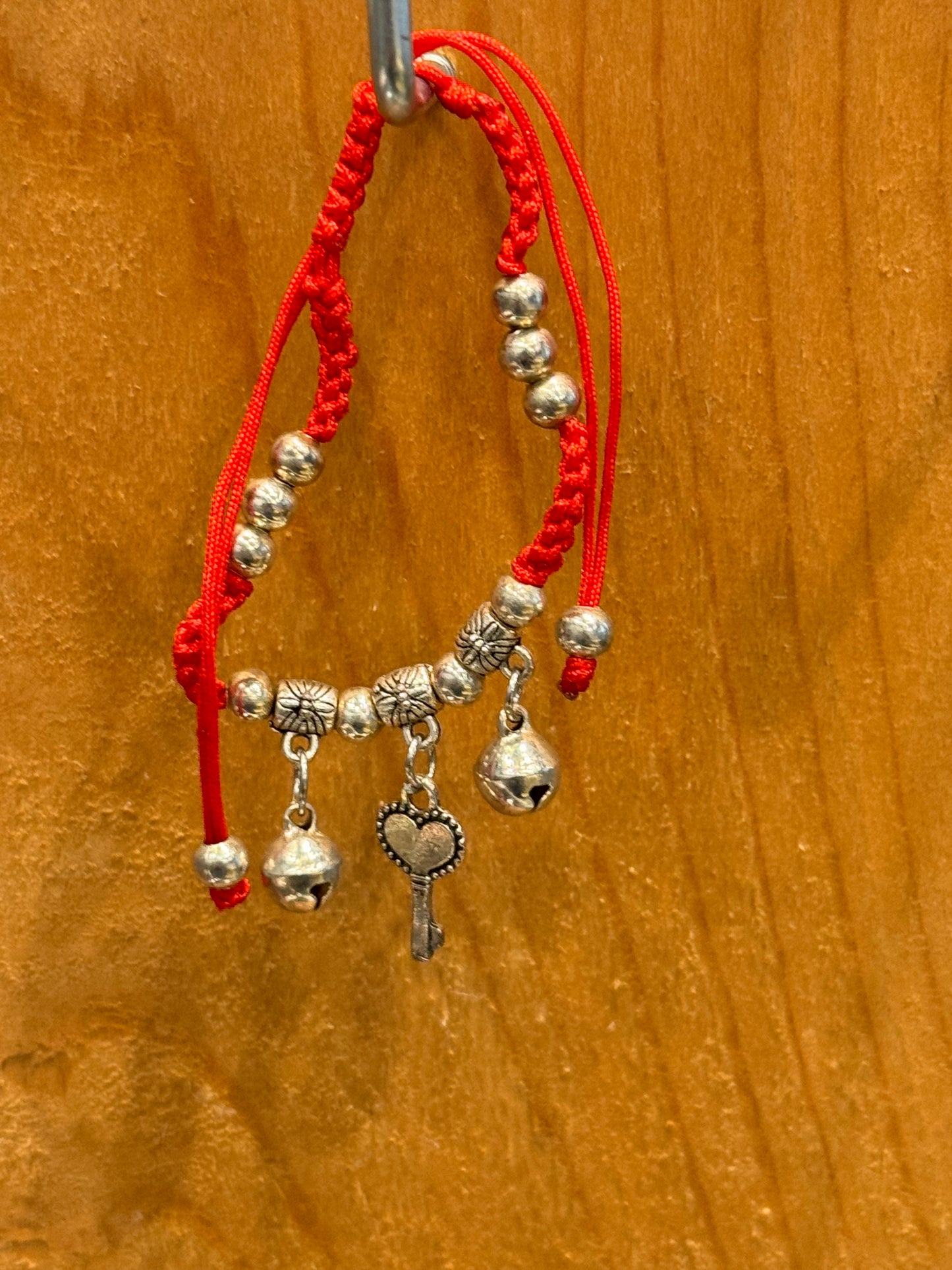 Red String Braided Pull Tie Bracelet with Silver Beads, Bells and Key Charm
