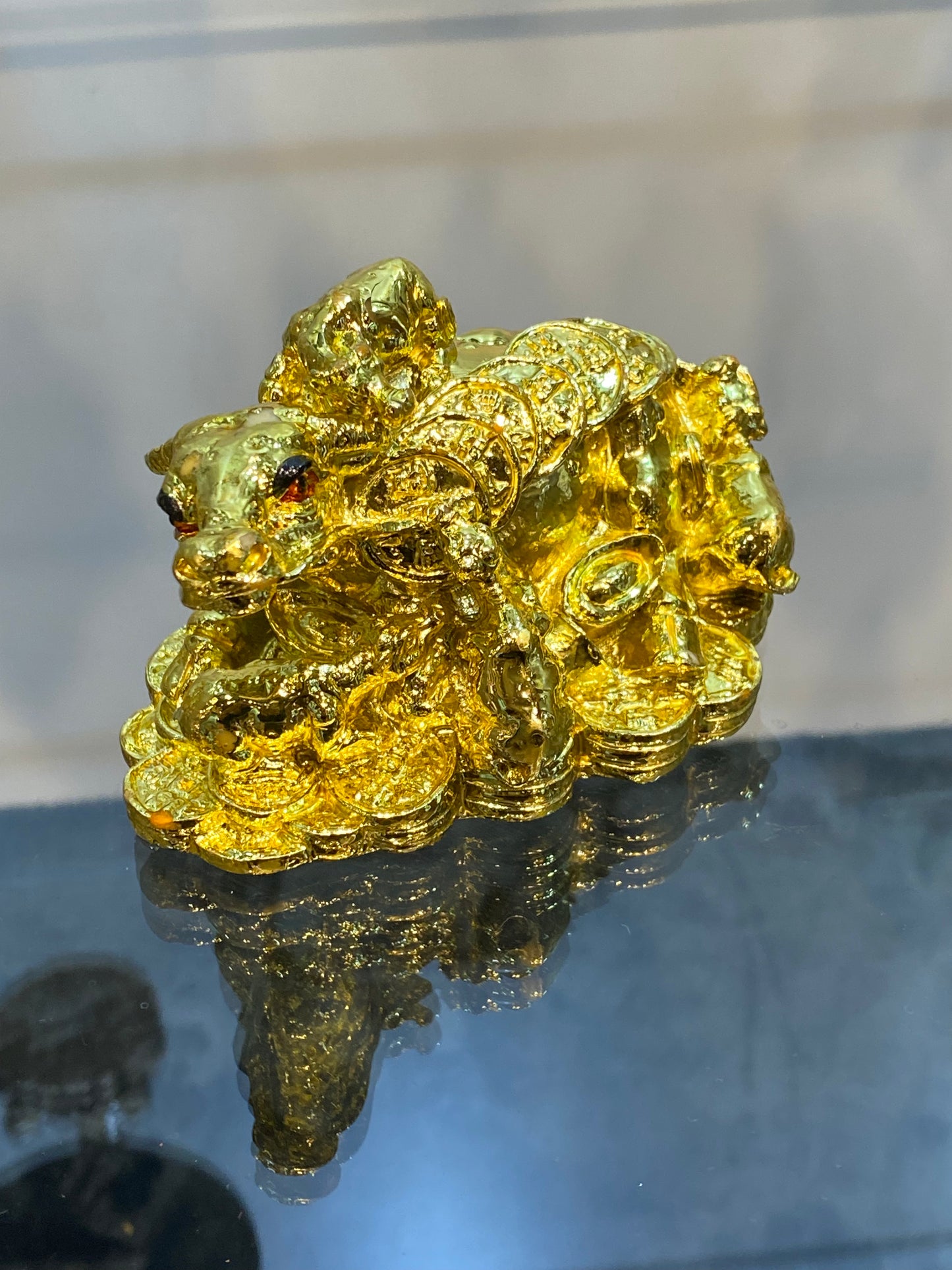 Feng Shui Shiny Gold Colored Money Ox With Baby Ox sitting on Coins
