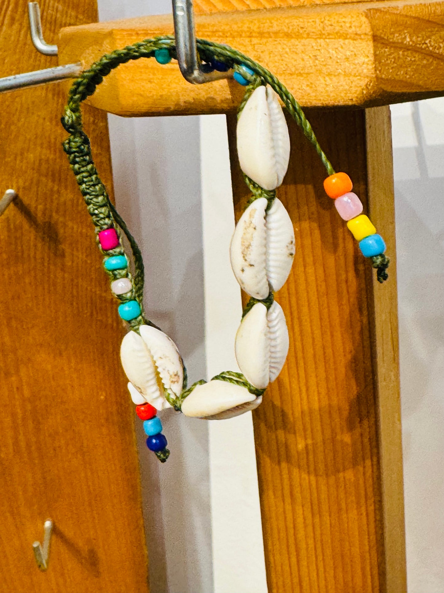 Handmade Army Green String Bracelet With Cowrie Shells and Colorful Beads “Boho charm meets ocean energy — wear abundance on your wrist.”