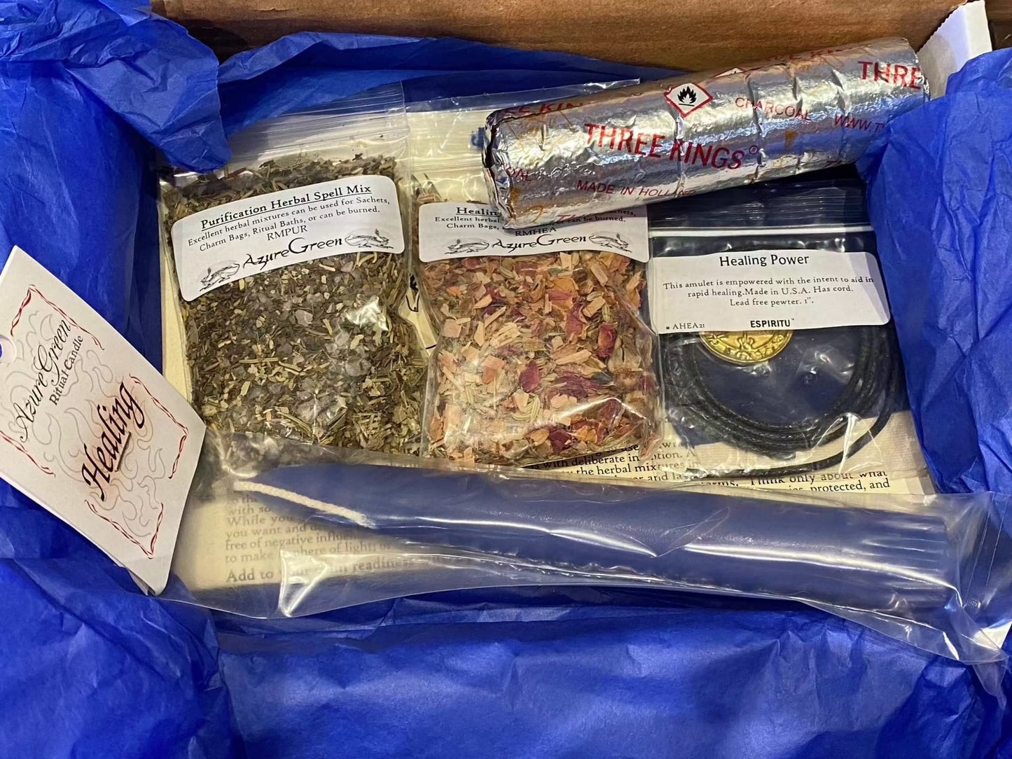 Healing Ritual Spell Kit with amulet, candle, herbal mixes, charcoal tablets, and bags.
