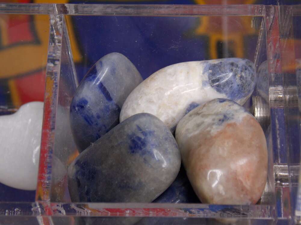 Sodalite Tumbled Stone for communication and self-expression in a clear box.