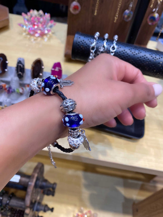 Leather Hamsa Dainty Bracelet with braided rope, glass beads, and a dangling charm.