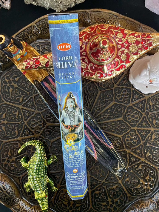 Hem Lord Shiva Incense Sticks packaging on ornate tray with decorative items.