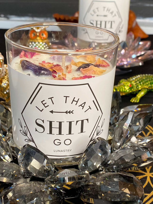 Crystal candle adorned with amethyst chips, rose petals, and glitter by Lunastry.