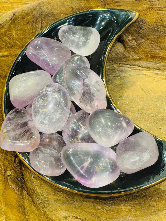 Amethyst Tumbled Stone on crescent dish showcasing violet hues.