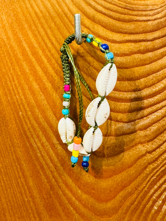 Handmade Army Green String Bracelet With Cowrie Shells and Colorful Beads “Boho charm meets ocean energy — wear abundance on your wrist.”