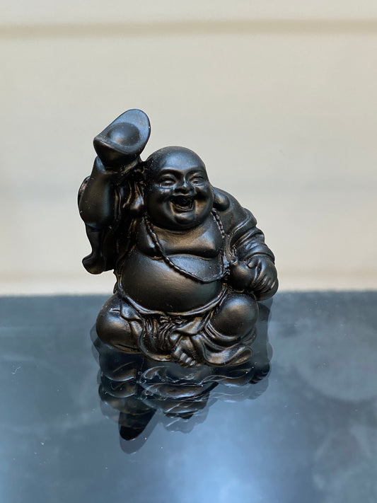 Black Laughing Buddha with Ingot and Gourd in his hands a symbol of abundance