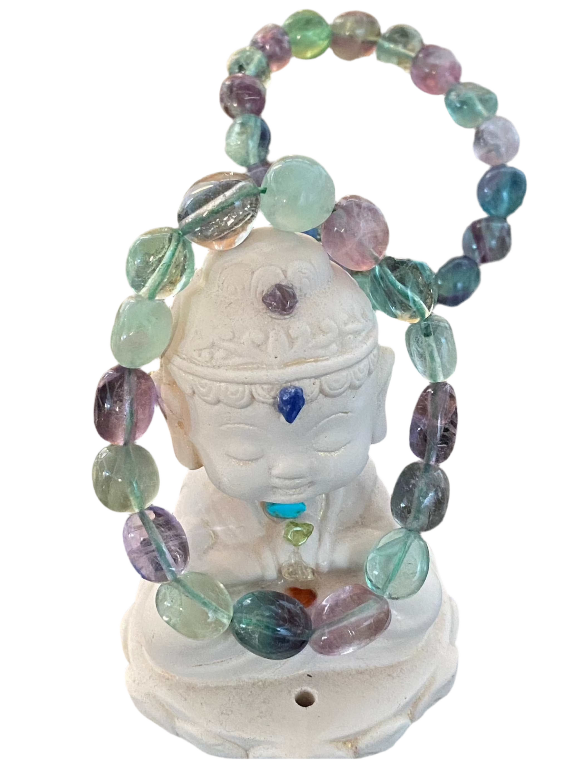 Rainbow Fluorite Round Tumbled Gemstone Bracelet with 8mm beads on a white statue.