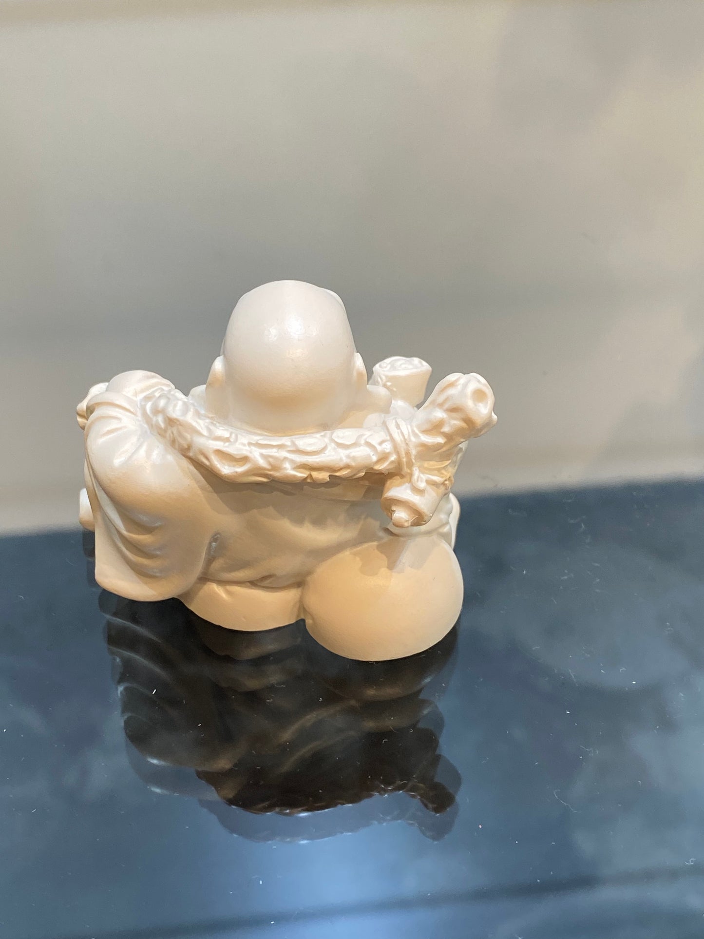 Ivory Laughing Sitting Buddha holding his Bag of Plenty