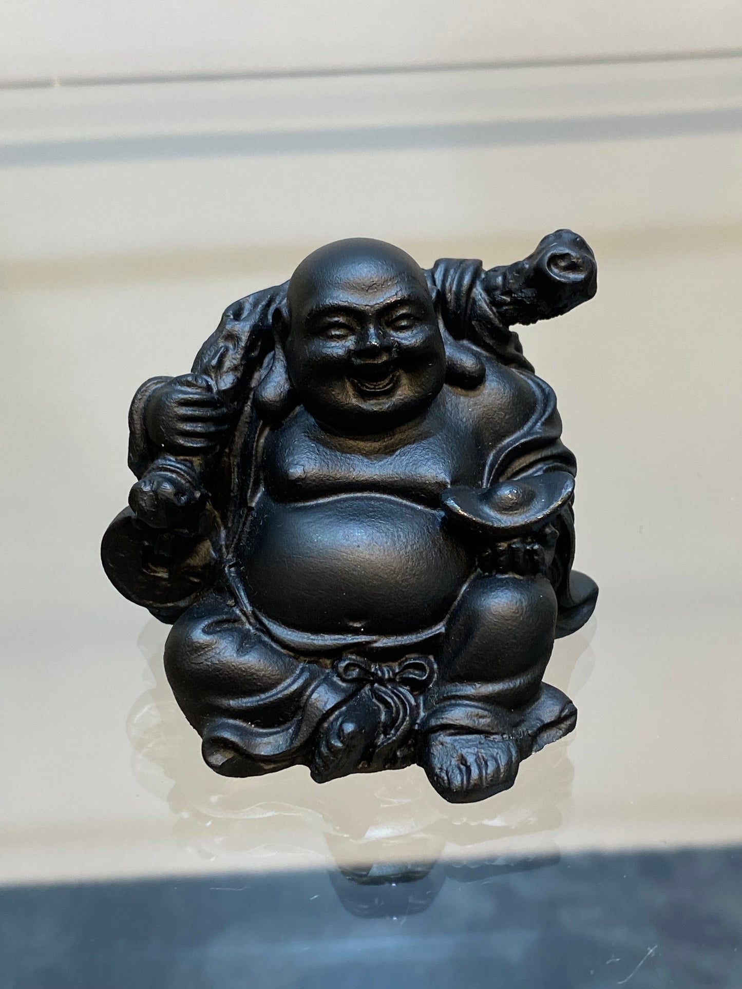 Black Mini Laughing Sitting Buddha with Bag of Plenty a symbol of abundance