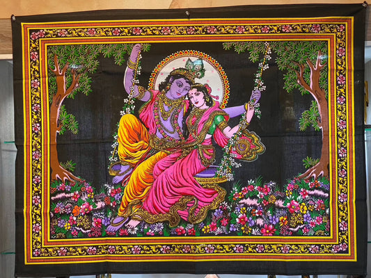 Lord Krishna and Goddess Radha tapestry featuring vibrant colors and intricate designs on a swing, perfect for wall decor.